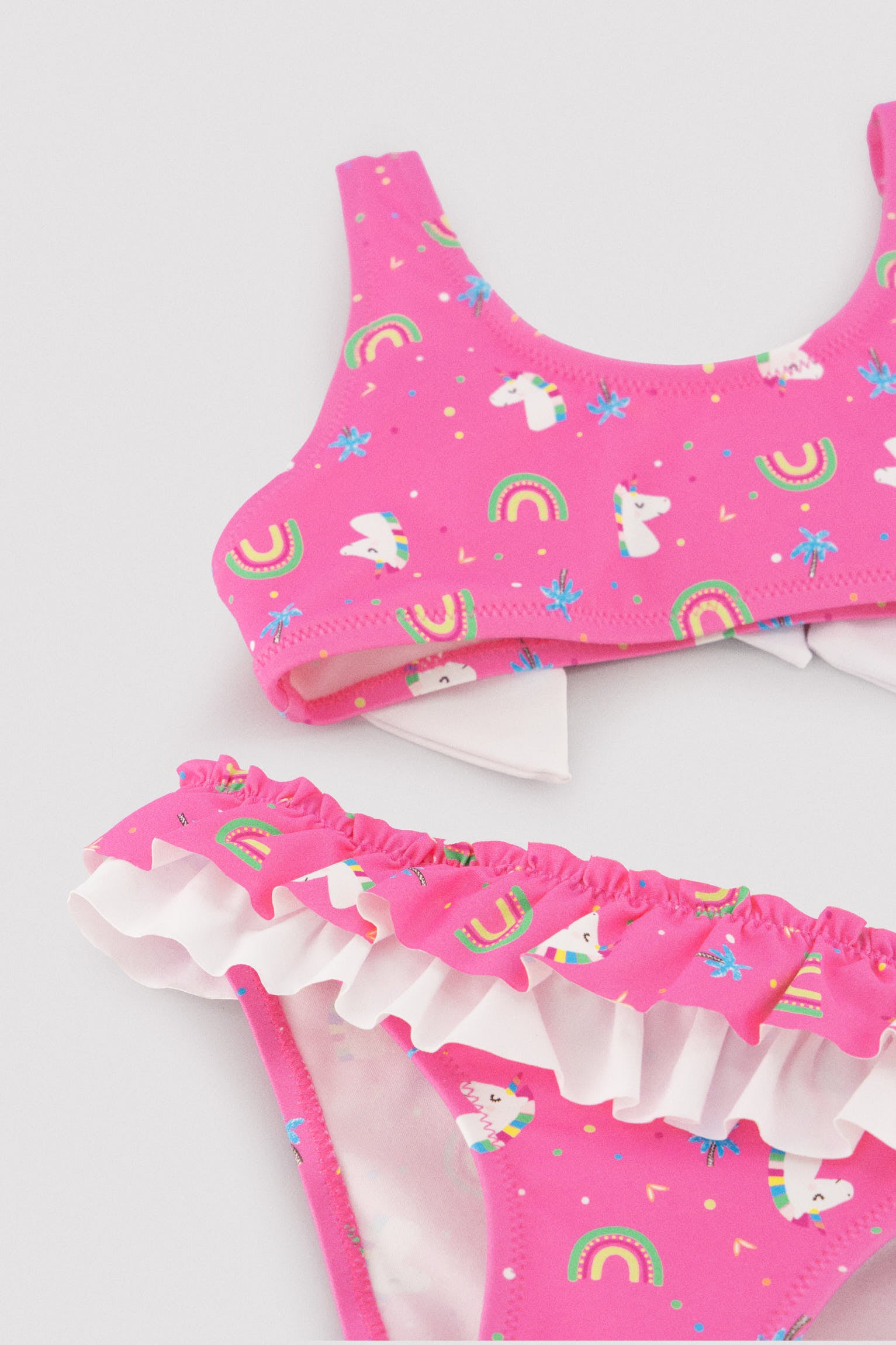 Bikini niña detalle volantes y lazos estampado unicornios
