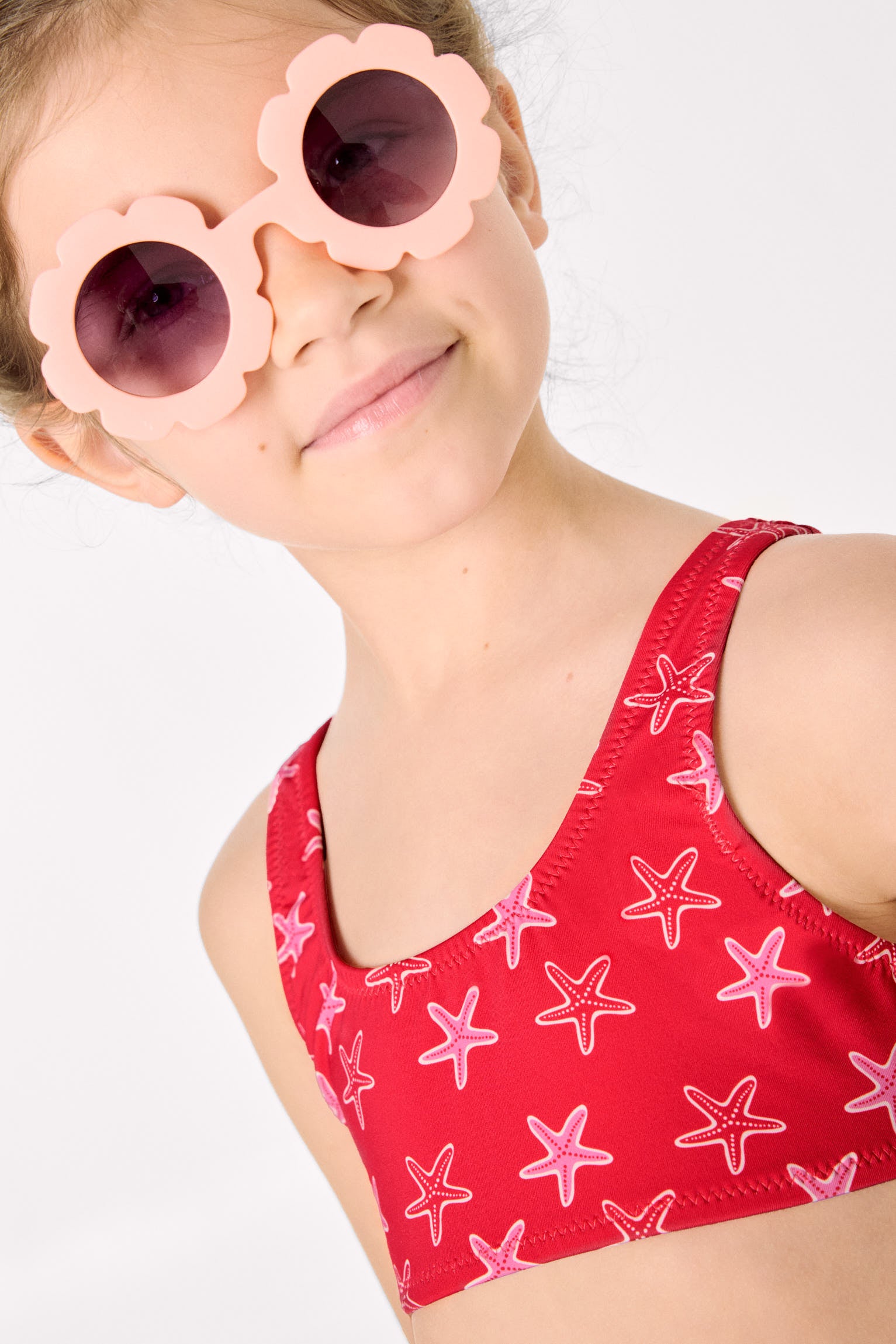 Bikini niña detalles volantes y lazos estampado estrellas marinas