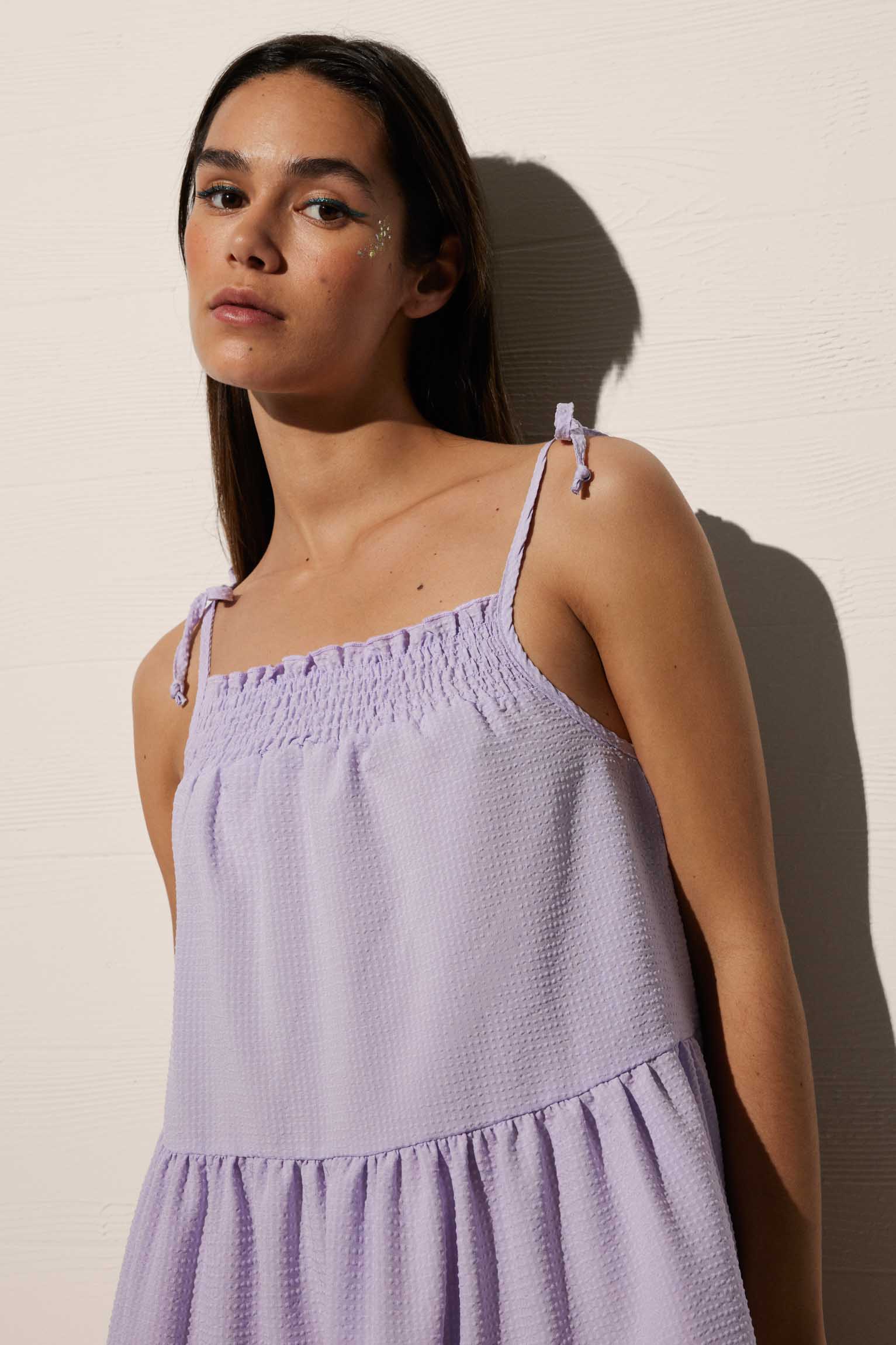 Short strap dress with gathered bow and lilac ruffles