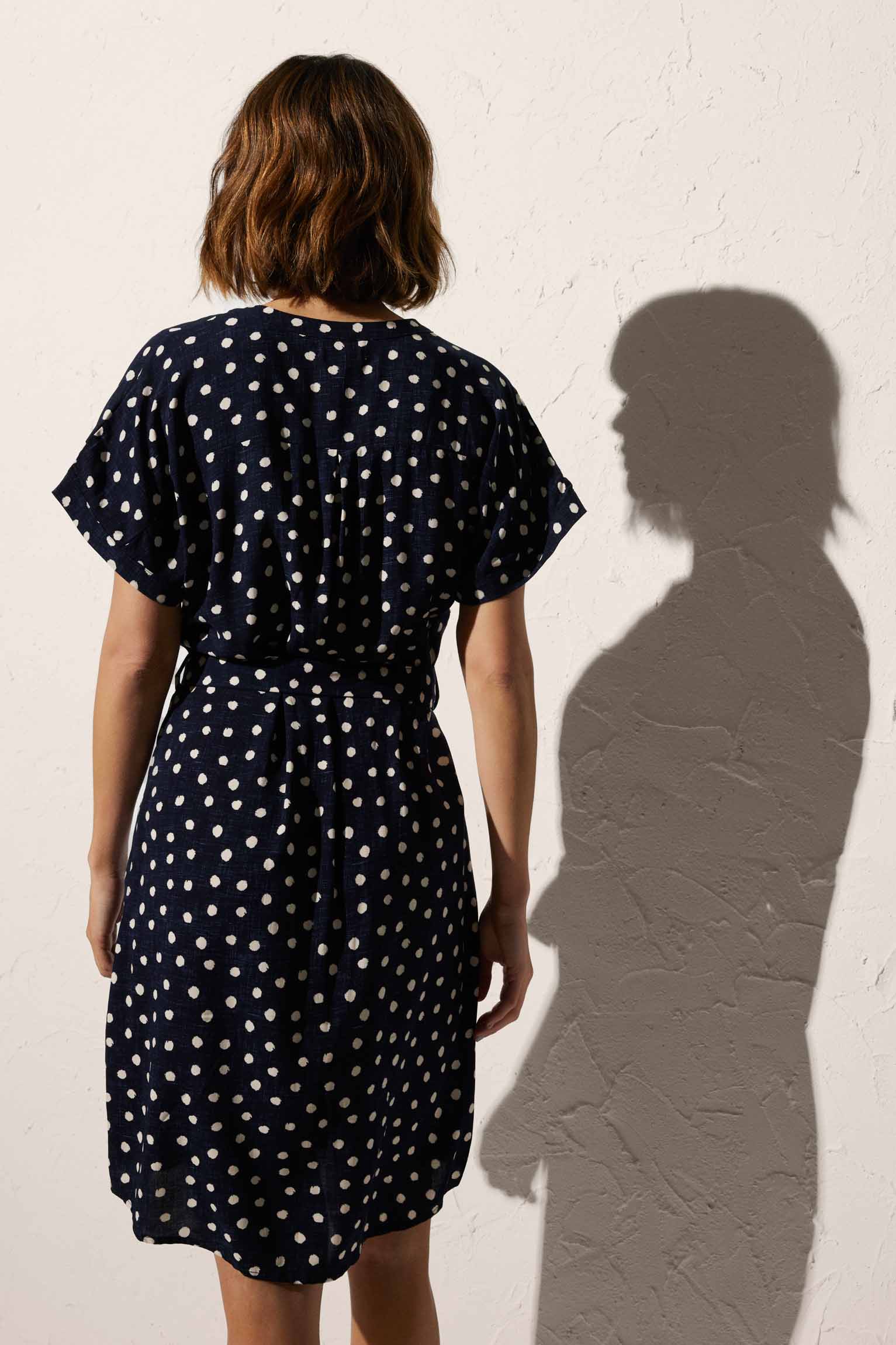 Short plumeti print beach dress with navy bow detail