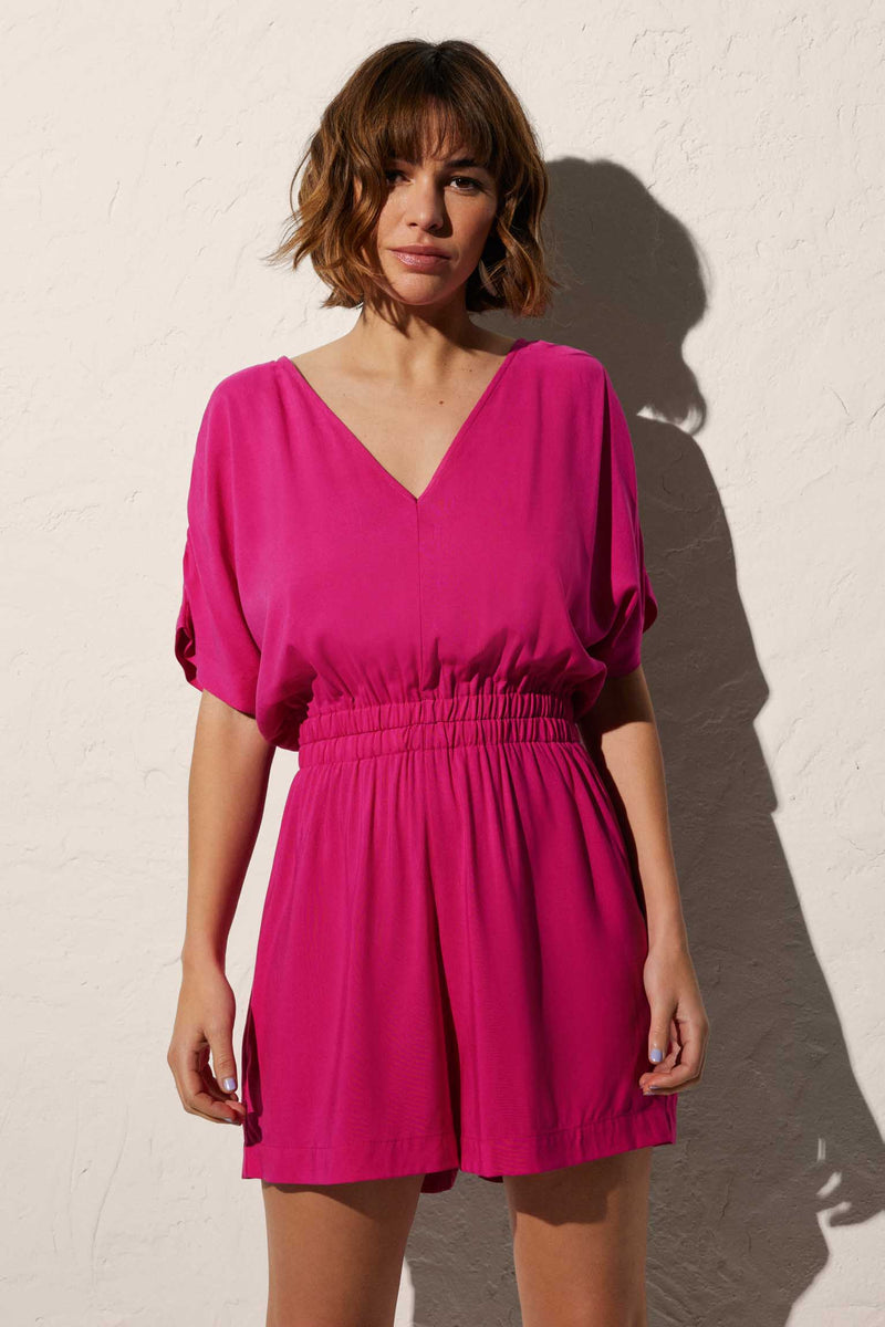 Short beach jumpsuit in plain fuchsia with gathered detail