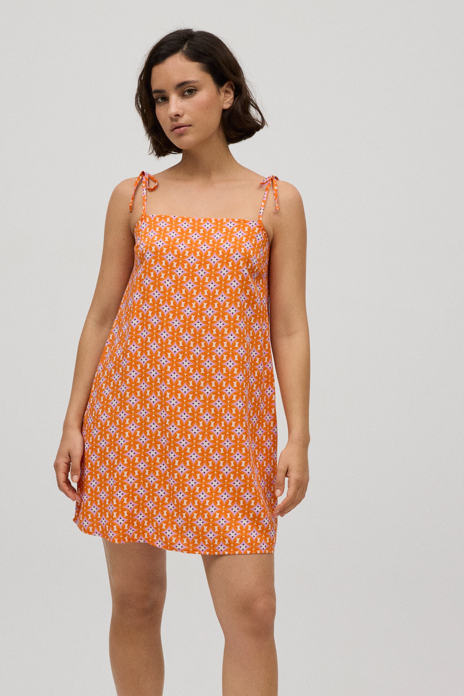 Geometric print short dress with knotted straps