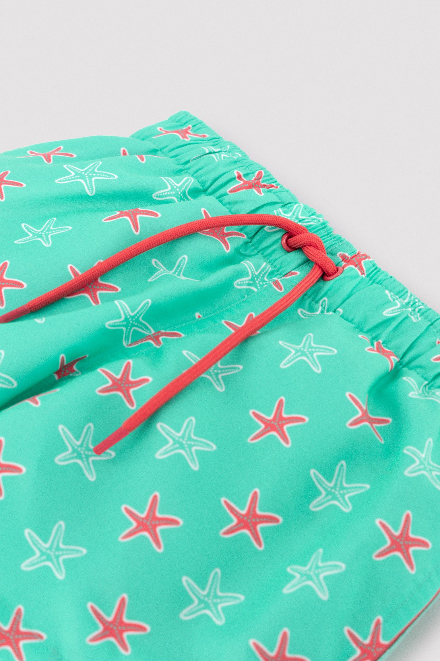 Bañdor niño corto estampado estrellas marinas turquesa - Ysabel Mora