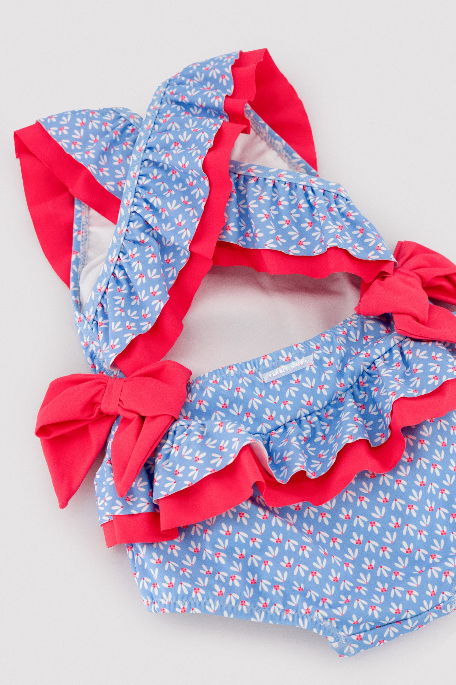 Bañador bebé niña detalles volantes y lazos estampado flores